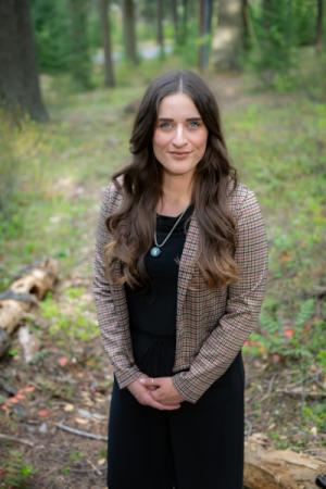 Weston's Assistant City Recorder, Danielle Anderson, is standing looking at the camera with her hands clasped in front of her. 
